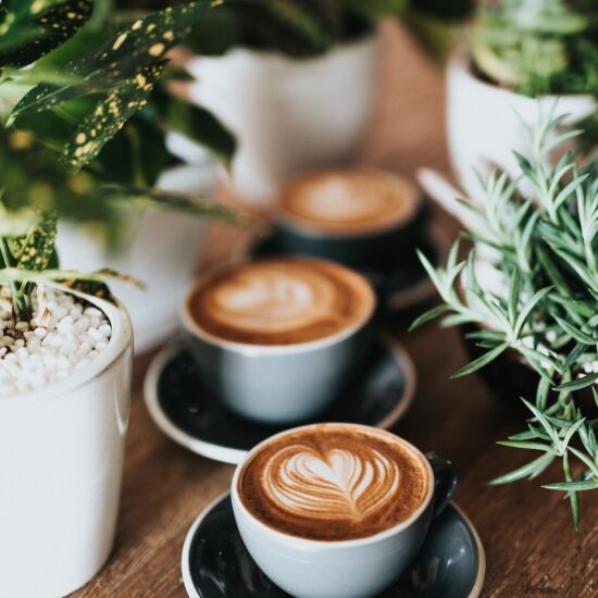 shallow focus photography of coffee late in mug on table